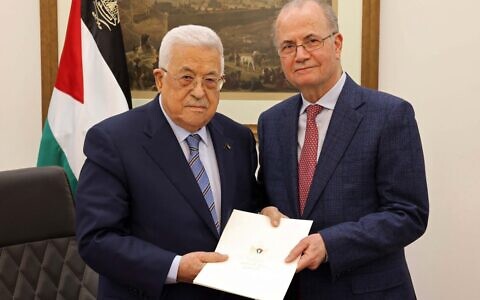 This handout picture provided by the Palestinian Authority's Press Office (PPO) shows Palestinian Authority President Mahmoud Abbas, left, with the newly appointed Palestinian Authority Prime Minister Mohammad Mustafa, in Ramallah on March 14, 2024. (Photo by PPO / AFP)