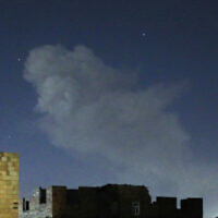 A plume of smoke rises after a reported airstrike in the Yemeni capital Sanaa on March 22, 2024. (Mohammed Huwais/AFP)