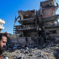 A man inspects the damage to a building after overnight Israeli bombardment in Rafah in the southern Gaza Strip on March 25, 2024. (MOHAMMED ABED / AFP)
