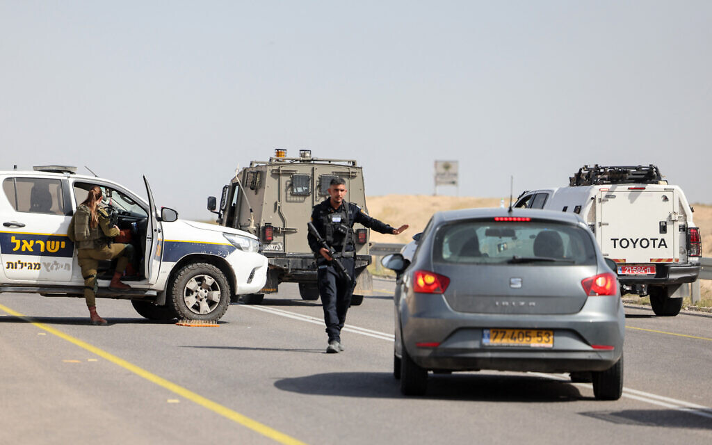 Security forces stop vehicles on a road in the West Bank following a shooting attack on March 28, 2024. (Ahmad Gharabli/AFP)