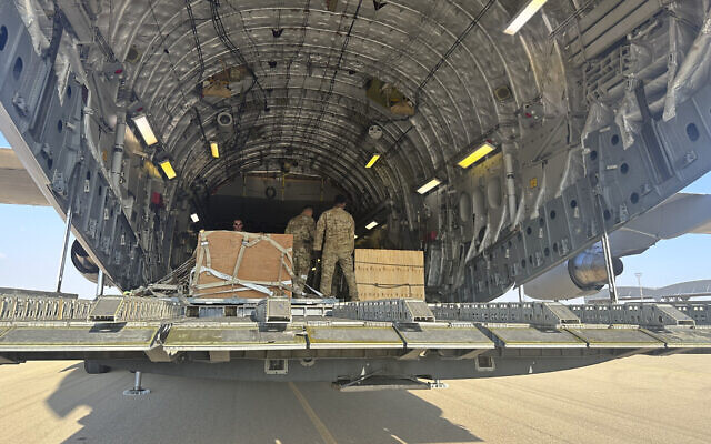 A U.S. C-17 sits at the Nevatim Air Base in the desert in Israel, Friday, Oct. 13, 2023 with crates of American munitions for Israel. (AP/Lolita Baldor)