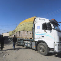 FILE - Humanitarian aid trucks enter the Gaza Strip from Israel through the Kerem Shalom crossing in Rafah, January 14, 2024. (AP Photo/Hatem Ali)