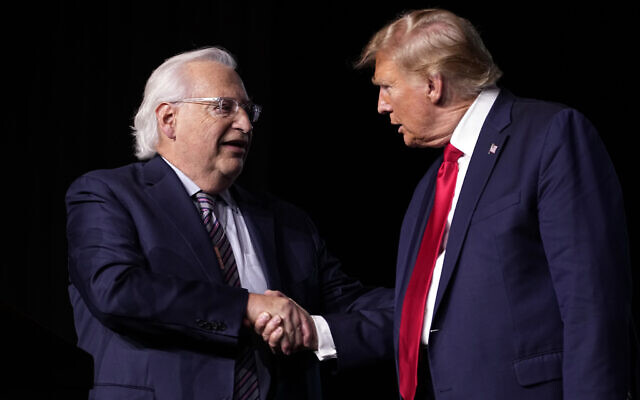Republican presidential candidate former president Donald Trump, right, greets David Friedman, who served as ambassador to Israel in the Trump administration, at the National Religious Broadcasters convention at the Gaylord Opryland Resort and Convention Center on February 22, 2024, in Nashville, Tennessee. (AP Photo/George Walker IV)