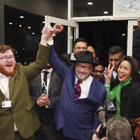 George Galloway, center, holds a rally at his Rochdale headquarters after being declared winner of the Rochdale by-election, which was triggered after the death of Labour Party's member of parliament Tony Lloyd, in Rochdale, England, Thursday, Feb. 29, 2024. (Peter Byrne/PA via AP)