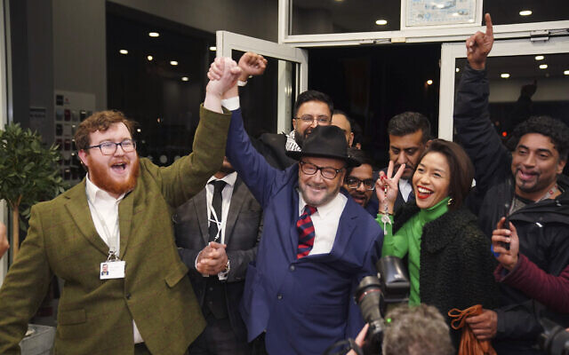 George Galloway, center, holds a rally at his Rochdale headquarters after being declared winner of the Rochdale by-election, which was triggered after the death of Labour Party's member of parliament Tony Lloyd, in Rochdale, England, Thursday, Feb. 29, 2024. (Peter Byrne/PA via AP)