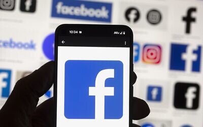 The Facebook logo is seen on a cell phone in Boston, October 14, 2022. (AP Photo/Michael Dwyer, File)