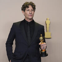 Jonathan Glazer poses with the award for best international feature film for "The Zone of Interest," in the press room at the Oscars on March 10, 2024, at the Dolby Theatre in Los Angeles. (Jordan Strauss/Invision/AP)