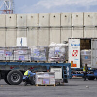Trucks carrying humanitarian aid for the Gaza Strip pass through the inspection area at the Kerem Shalom Crossing in southern Israel, March 14, 2024. (AP Photo/Ohad Zwigenberg)
