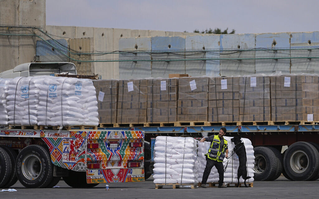 Trucks carrying humanitarian aid for the Gaza Strip pass through the inspection area at the Kerem Shalom Crossing in southern Israel, March 14, 2024. (AP/Ohad Zwigenberg)
