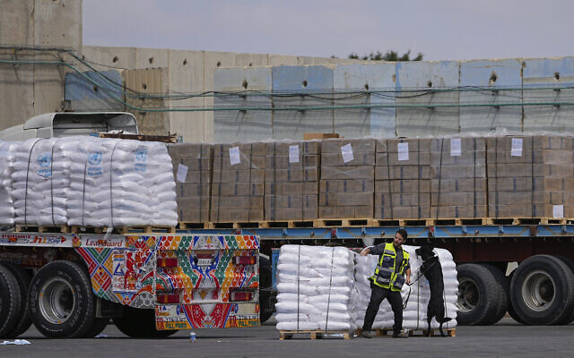 File - Trucks carrying humanitarian aid for the Gaza Strip pass through the inspection area at the Kerem Shalom Crossing in southern Israel, March 14, 2024. (AP/Ohad Zwigenberg)