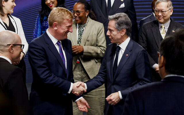 US Secretary of State Antony Blinken, right, shakes hands with Britain's Deputy Prime Minister Oliver Dowden during a photo session at the third Summit for Democracy in Seoul, South Korea, March 18, 2024. (Evelyn Hockstein/Pool Photo via AP)