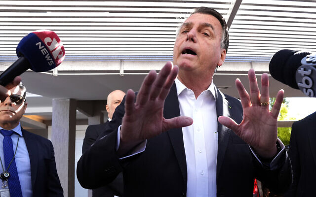 Former Brazilian president Jair Bolsonaro speaks to the press outside his home after Federal Police agents carried out a search and seizure warrant in Brasilia, Brazil, May 3, 2023. (AP/Eraldo Peres)