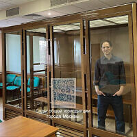 In this photo released by the Moscow City Court Press Service, Wall Street Journal reporter Evan Gershkovich stands in a glass cage in a courtroom at the Moscow City Court in Moscow, Russia, March 26, 2024. (Moscow City Court Press Service via AP)