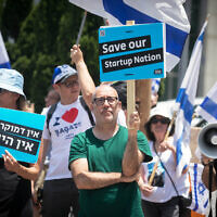 Israeli tech employees and activists protest against the government's planned judicial overhaul at Ramat Hahayal, Tel Aviv, July 4, 2023. (Miriam Alster/Flash90)
