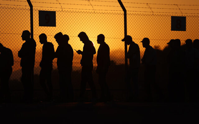 Palestinian workers stand in line at the Erez crossing to Israel, September 28, 2023. (Atia Mohammed/Flash90)