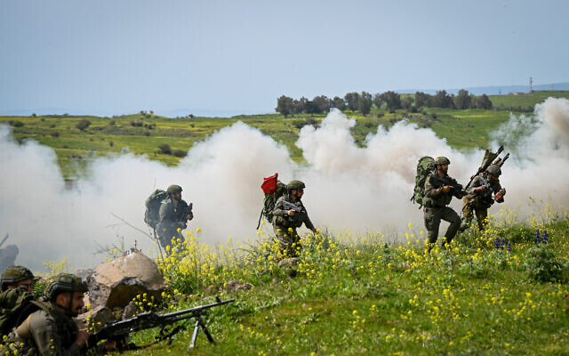 Israeli reserve soldiers train with their unit in urban warfare in northern Golan Heights, on March 27, 2024. (Michael Giladi/Flash90)