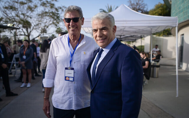 Yesh Atid leadership challenger MK Ram Ben Barak (left) and party leader Yair Lapid meet during elections for the leadership in Tel Aviv, March 28, 2024. (Avshalom Sassoni/FLASH90)