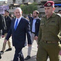 From left: Defense Minister Yoav Gallant, Prime Minister Benjamin Netanyahu and IDF Chief of Staff Lt. Gen. Herzi Halevi at a cadets graduation ceremony at the IDF's officers school in southern Israel, known as Bahad 1, March 7, 2024. (Amos Ben Gershom/GPO)