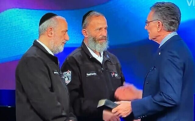 Yossi Landau, center, stands on stage with his brother Jacob and Pastor George Pearsons on February 2, 2024 in Newark, Texas. (Screenshot taken from the Facebook page of Eagle Mountain International Church)