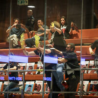 Protesters smear yellow paint on the windows of the Knesset plenum visitors gallery, April 3, 2024. (Noam Moskowitz, Office of the Knesset Spokesperson)