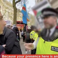 A screenshot from video released by the Campaign Against Antisemitism shows a London Metropolitan Police officer threatening a Jewish man with arrest because his presence is "antagonizing" to pro-Palestinian demonstrators at an anti-Israel march in London, April 13, 2024. (X video screenshot; used in accordance with Clause 27a of the Copyright Law)