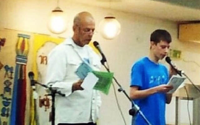 Hostage Chaim Peri (left) and his grandson, Mai Albini, at an earlier Passover in Kibbutz Nir Oz. (Screenshot/Courtesy)
