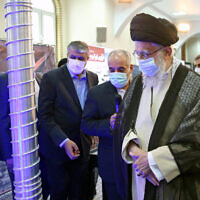 Illustrative: Ayatollah Ali Khamenei (front) visits an exhibition of the country's nuclear industry achievements in Tehran, June 11, 2023, accompanied by the head of the Atomic Energy Organization of Iran Mohammad Eslami (L). (Khamenei.ir/AFP)