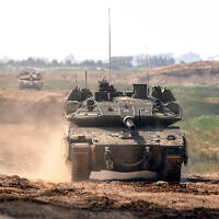 An Israeli army vehicle moves along the Gaza border, March 19, 2024. (Jack Guez / AFP)