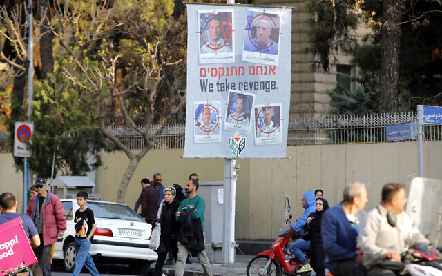 A banner displaying pictures of Israeli army officials with their faces encircled by a red crosshair icon hangs in Tehran on April 2, 2024, following a suspected Israeli strike in Damascus that killed the top IRGC officer in Syria. (Atta Kenare/AFP)