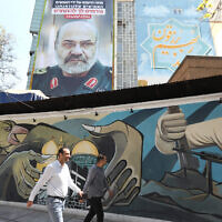 A billboard displays a portrait of slain Iranian Brigadier General Mohammad Reza Zahedi with a slogan in Hebrew saying, "You will be punished," on April 3, 2024 at Palestine Square in Tehran. (ATTA KENARE / AFP)