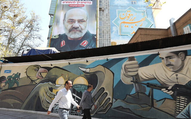 A billboard displays a portrait of slain Iranian Brigadier General Mohammad Reza Zahedi with a slogan in Hebrew saying, "You will be punished," on April 3, 2024, at Palestine Square in Tehran. (ATTA KENARE / AFP)