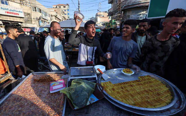 Palestinians sell sweets in Rafah in the southern Gaza Strip on April 9, 2024. (Mohammed Abed/AFP)