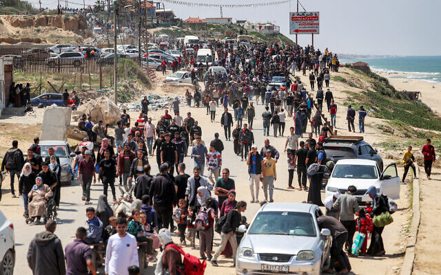Displaced Palestinians taking the coastal Rashid road as they attempt to return to Gaza City pass through Nuseirat in the central Gaza Strip, on April 14, 2024. (AFP)