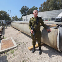 IDF spokesman Rear Adm. Daniel Hagari next to an Iranian ballistic missile that fell in Israel over the weekend, at the Julis military base in the south, April 16, 2024. (GIL COHEN-MAGEN / AFP)