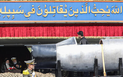 An Iranian military truck carries an underwater military equipment past President Ebrahim Raisi (L) and army officers during a military parade as part of a ceremony marking the country's annual army day in Tehran on April 17, 2024. (ATTA KENARE / AFP)
