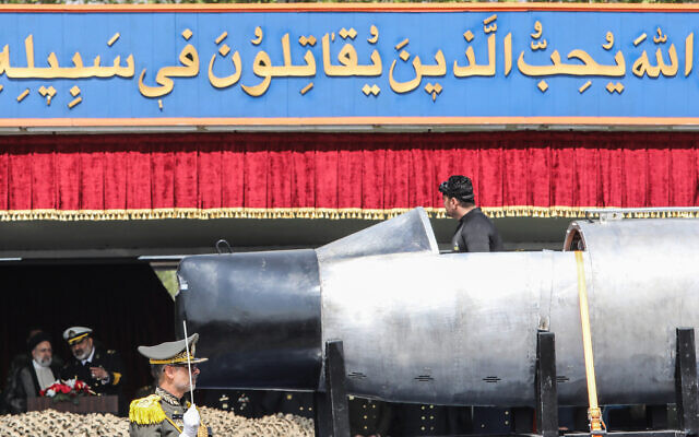 An Iranian military truck carries an underwater military equipment past President Ebrahim Raisi (L) and army officers during a military parade as part of a ceremony marking the country's annual army day in Tehran on April 17, 2024. (ATTA KENARE / AFP)