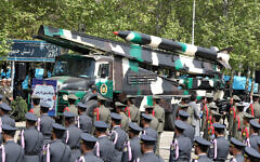 An Iranian military truck carries missiles during a military parade as part of a ceremony marking the country's annual army day in Tehran on April 17, 2024. (Photo by ATTA KENARE / AFP)