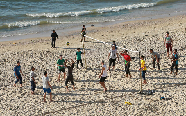 Palestinians play volleyball on a beach in Deir el-Balah in the central Gaza Strip on April 17, 2024, amid the ongoing conflict between Israel and Hamas. (Photo by AFP)