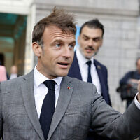 France's President Emmanuel Macron gestures as he leaves after a meeting of Renew Europe group prior to the European Defense and Security conference at the EU headquarters in Brussels on April 17, 2024. (Ludovic MARIN / AFP)