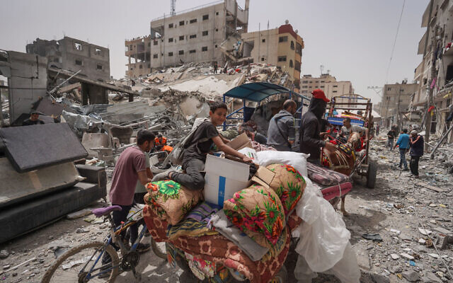 Palestinians pack their belongings in a truck as they leave their home in the city of Nuseirat in the central Gaza Strip on April 18, 2024. (AFP)