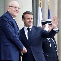 French President Emmanuel Macron (R) welcomes Lebanese Prime Minister Najib Mikati (L) before a meeting at the Elysee Palace in Paris on April 19, 2024. (Ludovic Marin/AFP)