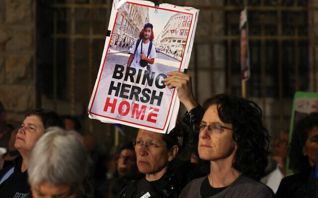Demonstrators at rally for hostages held captive by Hamas hold a picture of US-Israeli Hersh Goldberg-Polin near the Prime Minister's Residence in Jerusalem on April 20, 2024. (Ahmad Gharabli/AFP)