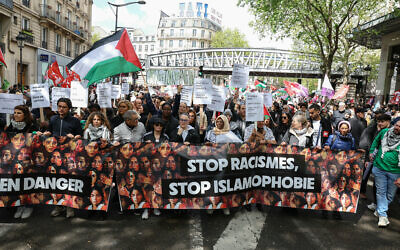 Demonstrators hold a banner reading 'Stop racism, stop Islamophobia,' during a protest in Paris on April 21, 2024. (Alain Jocard/AFP)