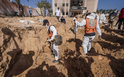 Palestinian health workers dig for bodies buried at Nasser Hospital compound in Khan Younis in the southern Gaza Strip on April 21, 2024. (AFP)