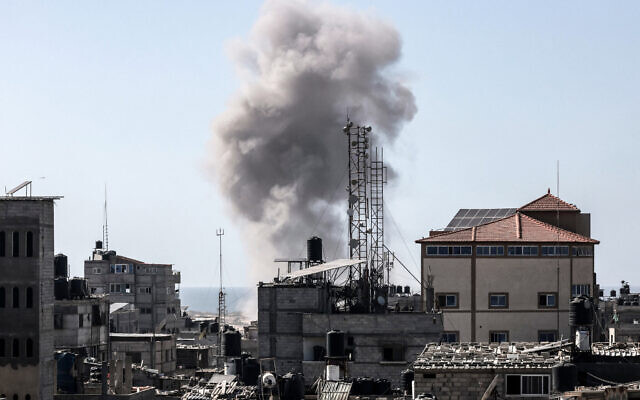 Smoke rises above buildings during an Israeli strike in Rafah in the southern Gaza Strip on April 21, 2024, amid the ongoing fighting between Israel and the Hamas terror movement. (Mohammed Abed/AFP)