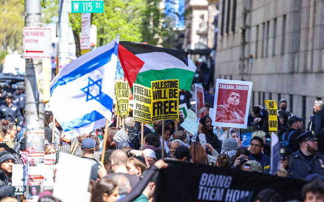 Pro-Palestinian and pro-Israel demonstrators face off in front of the entrance of Columbia University, which is occupied by pro-Palestinian protesters in New York on April 22, 2024. One of the pro-Palestinian demonstrators is holding up a poster of Zakaria Zubeidi, a notorious Fatah commander convicted of masterminding terror attacks during the Second Intifada. (Photo by Charly TRIBALLEAU / AFP)