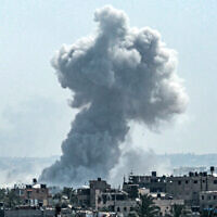 A smoke plume billows following Israeli strike north of Nuseirat in the central Gaza Strip on April 23, 2024. (AFP)