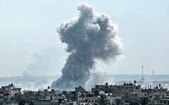 A smoke plume billows following Israeli strike north of Nuseirat in the central Gaza Strip on April 23, 2024. (AFP)