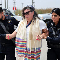 Israeli police officers arrest a member of the group 'Rabbis for Ceasefire' during their march toward the Erez crossing on the border with northern Gaza Strip on April 26, 2024. (Jack Guez/AFP)