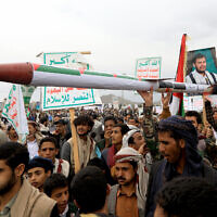 Yemeni demonstrators carry a mock missile during a pro-Palestinian and anti-Israel rally in the Houthi-held capital Sanaa on April 26, 2024. (Mohammed Huwais/AFP)